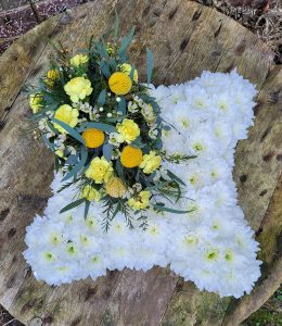 Funeral tribute cushion with yellow top spray